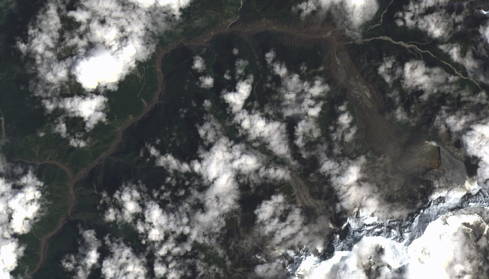 Satellite view of the Bhote Koshi valley in Rasuwa before and after the flood, showing the river channel widened into a broad scar of mud and debris.